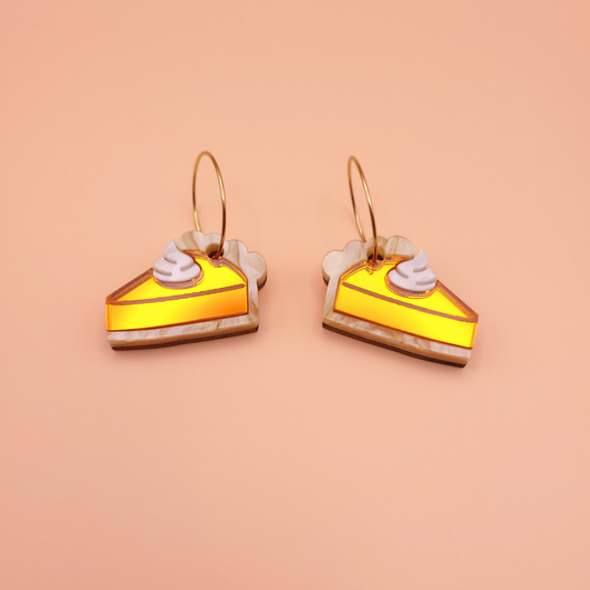 Acrylic pumpkin pie slice earrings with whipped cream detail on gold hoops — cozy dessert statement jewellery by Pop Heart Studio