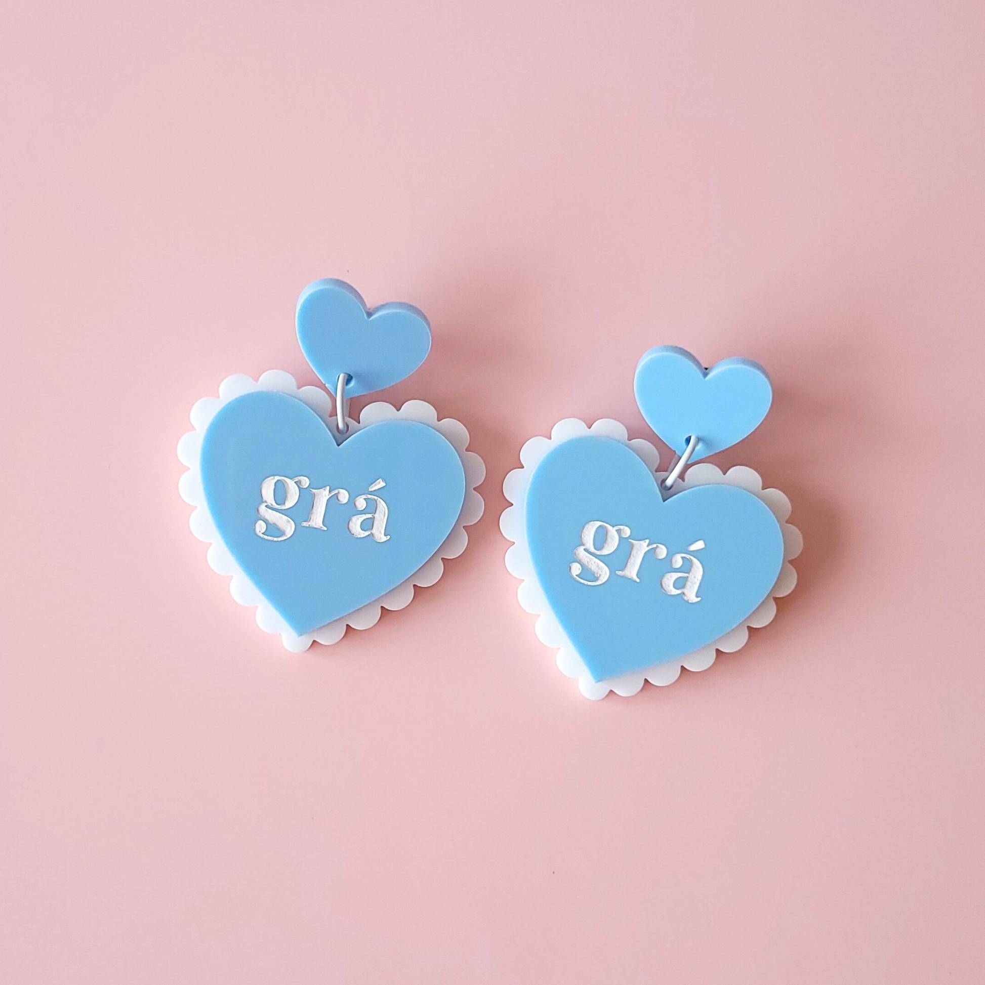 Lightweight acrylic heart drop earrings with scalloped edge and “grá” lettering