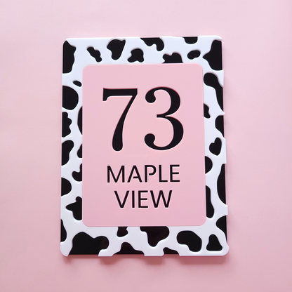 Custom cow print house number sign in pastel pink and black acrylic, handmade in Ireland