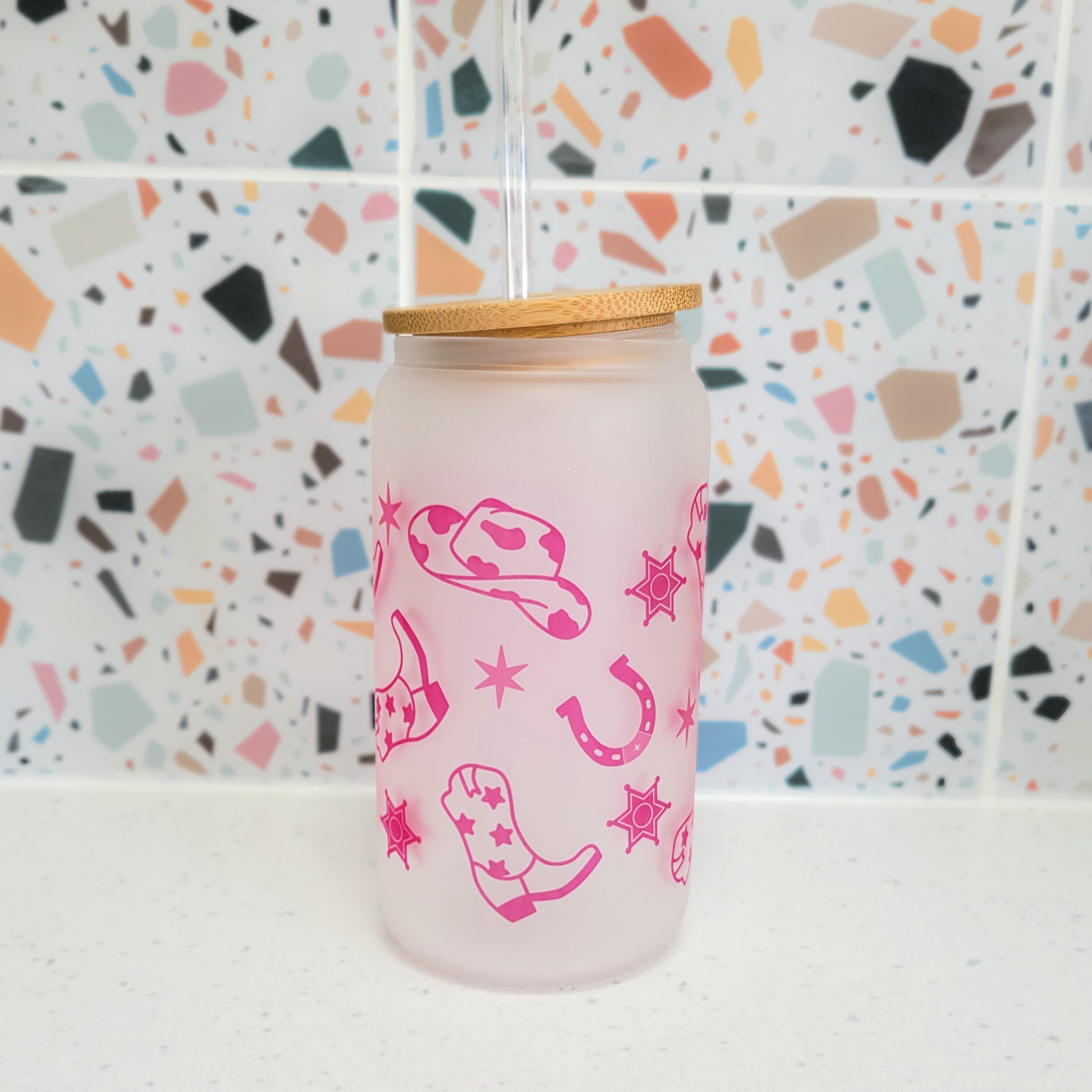 Frosted glass cup featuring Western icons in pink, eco-friendly drinkware