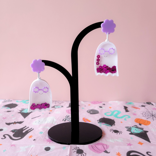 Acrylic shaker ghost earring with purple flower sunglasses, smile detail, and pink sequin flowers inside, attached to a purple flower stud.