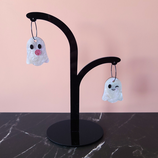 Acrylic ghost earrings blowing a pink glitter bubble, hanging from stainless steel hoops — playful spooky-cute statement jewellery by Pop Heart Studio.
