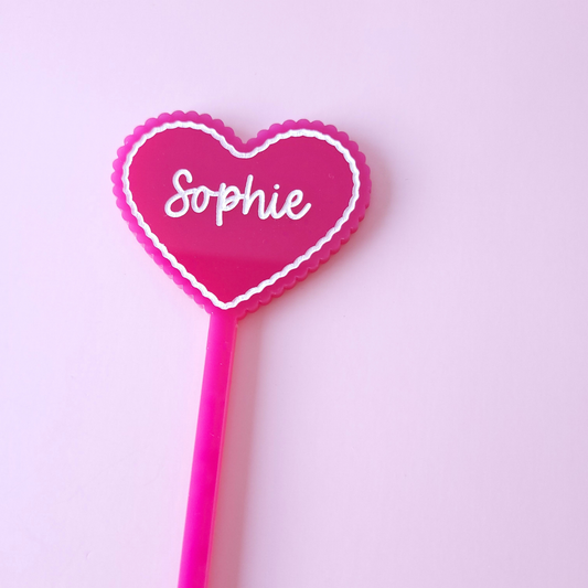 Personalised pink acrylic heart drink stirrer with name Sophie on pastel background