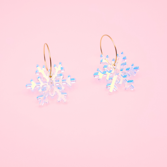 Iridescent holographic acrylic snowflake earrings on gold hoops — handmade winter dangle earrings.