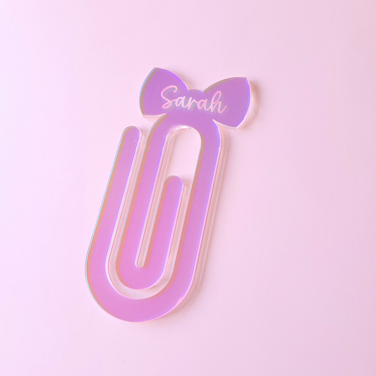 Iridescent acrylic bow bookmark with custom name Sarah on pastel background