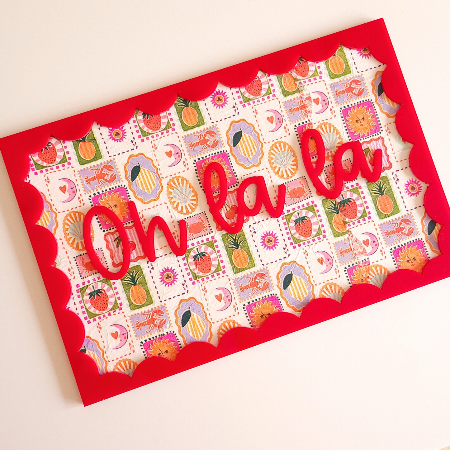 Oh la la wall art with glossy red acrylic scalloped frame and colourful decoupage background