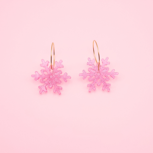 Pink glitter acrylic snowflake earrings on gold hoops — handmade cute winter dangle earrings.