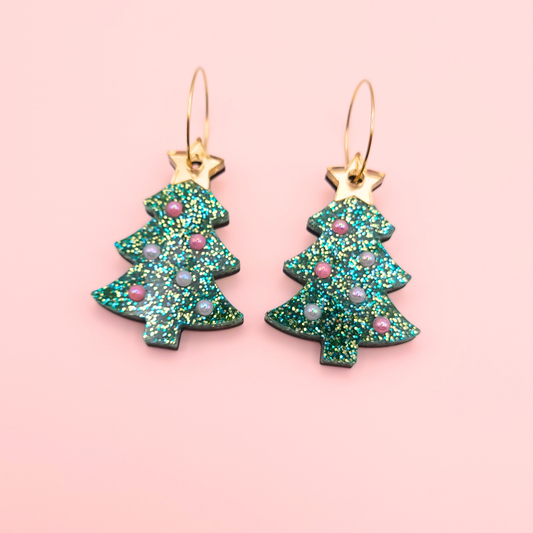 Green glitter Christmas tree earrings with pastel pearl ornaments and a mirror gold star topper on gold hoops — handmade festive jewellery.